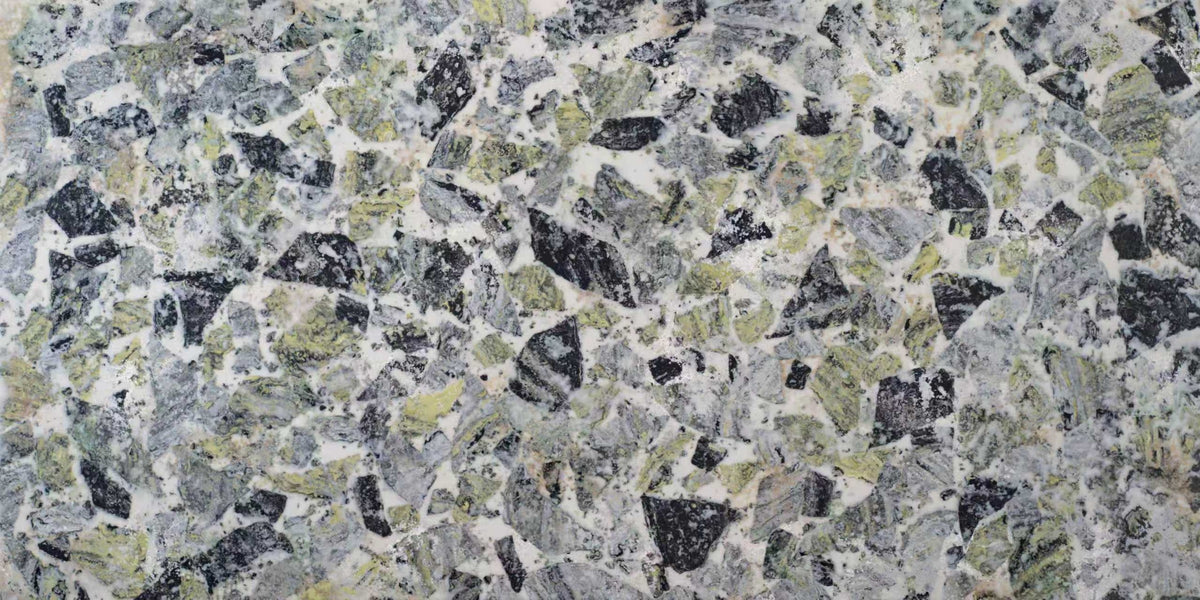 Lacoste Green quartz slab, terrazzo inspired sage green, charcoal and gray fragments on white, polished finish