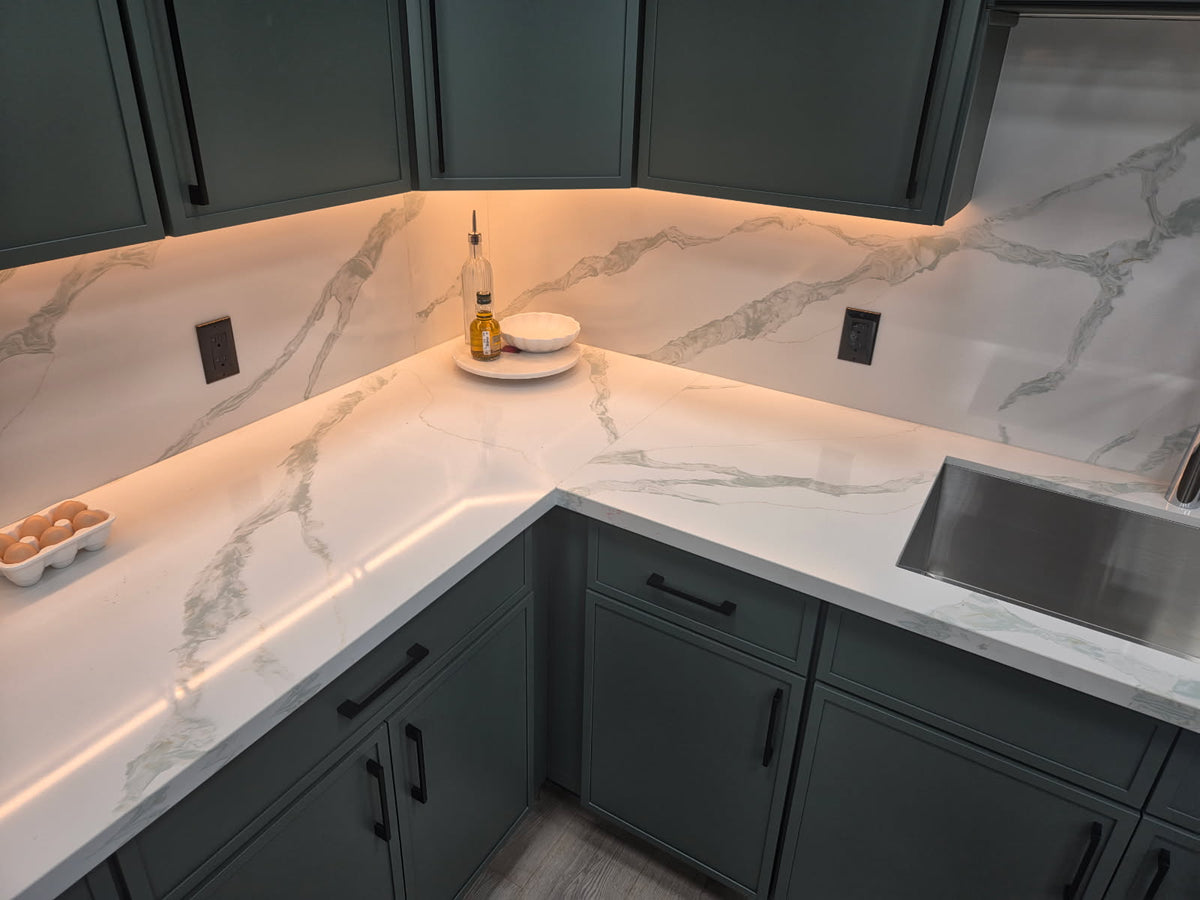 HC-Calacatta Emerald quartz countertop and full-height backsplash installed in a kitchen with green cabinets