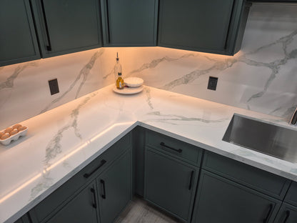 HC-Calacatta Emerald quartz countertop and full-height backsplash installed in a kitchen with green cabinets
