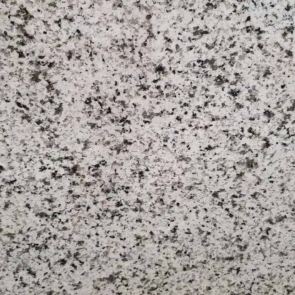 Verde Perla granite slab, white base with black sparkle and crystal flecks, polished finish