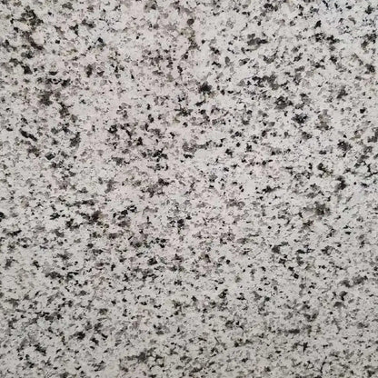 Verde Perla granite slab, white base with black sparkle and crystal flecks, polished finish