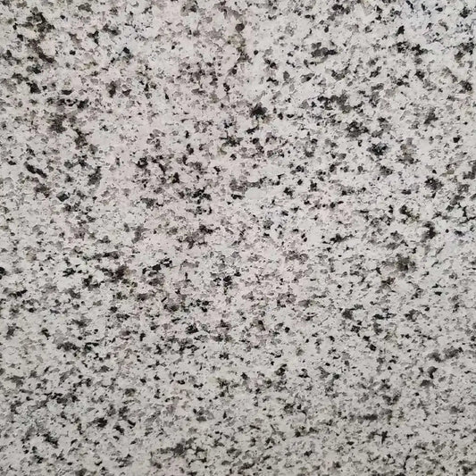 Verde Perla granite slab, white base with black sparkle and crystal flecks, polished finish