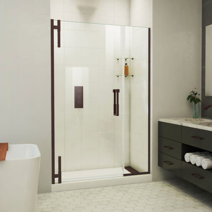 Ascend frameless pivot shower door with inline panel in Oil Rubbed Bronze, 40 to 49 1/2 inch width, 3/8 inch clear glass, shown in a bathroom
