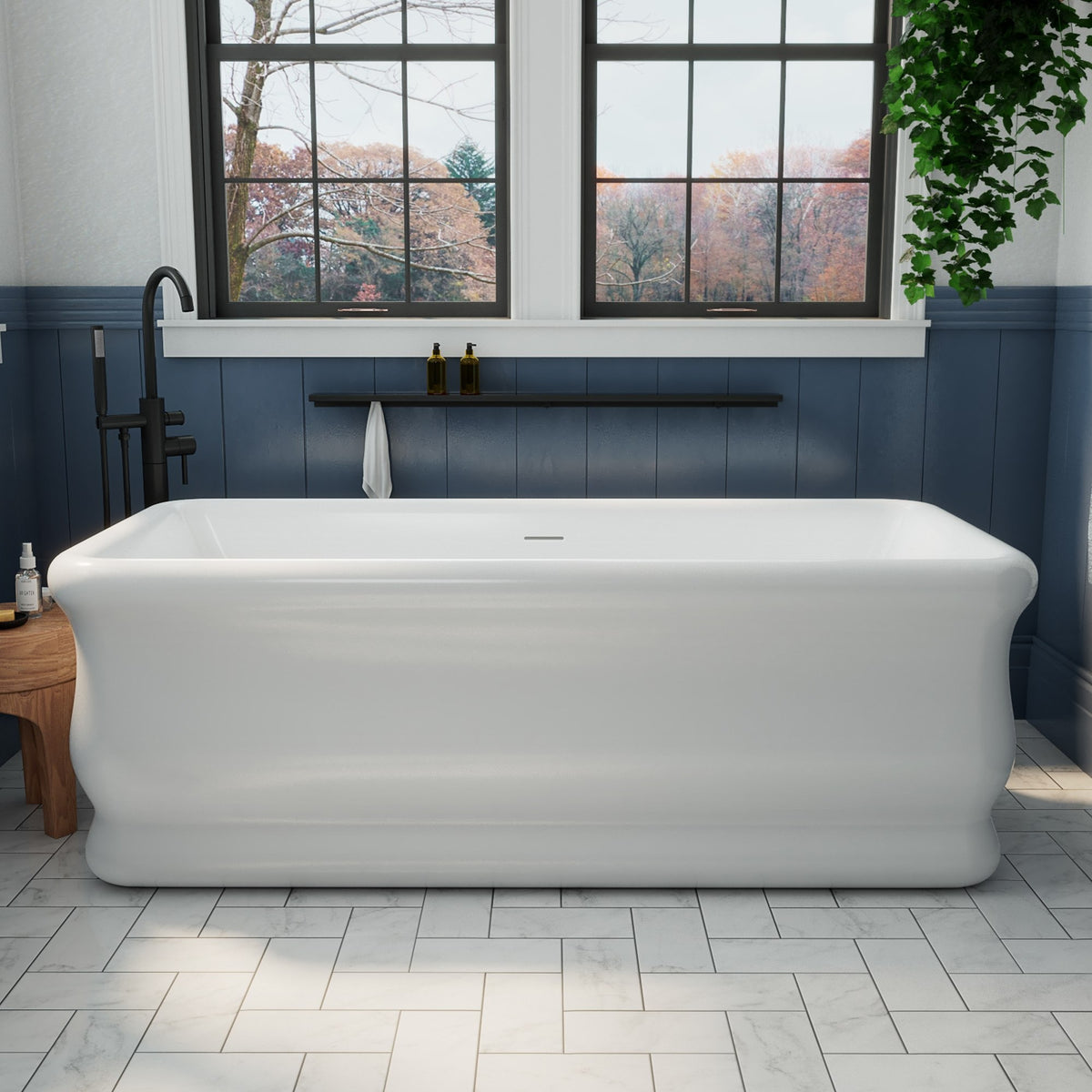 Crest 71 inch freestanding acrylic bathtub in gloss white with Brushed Brass drain, shown in a styled setting