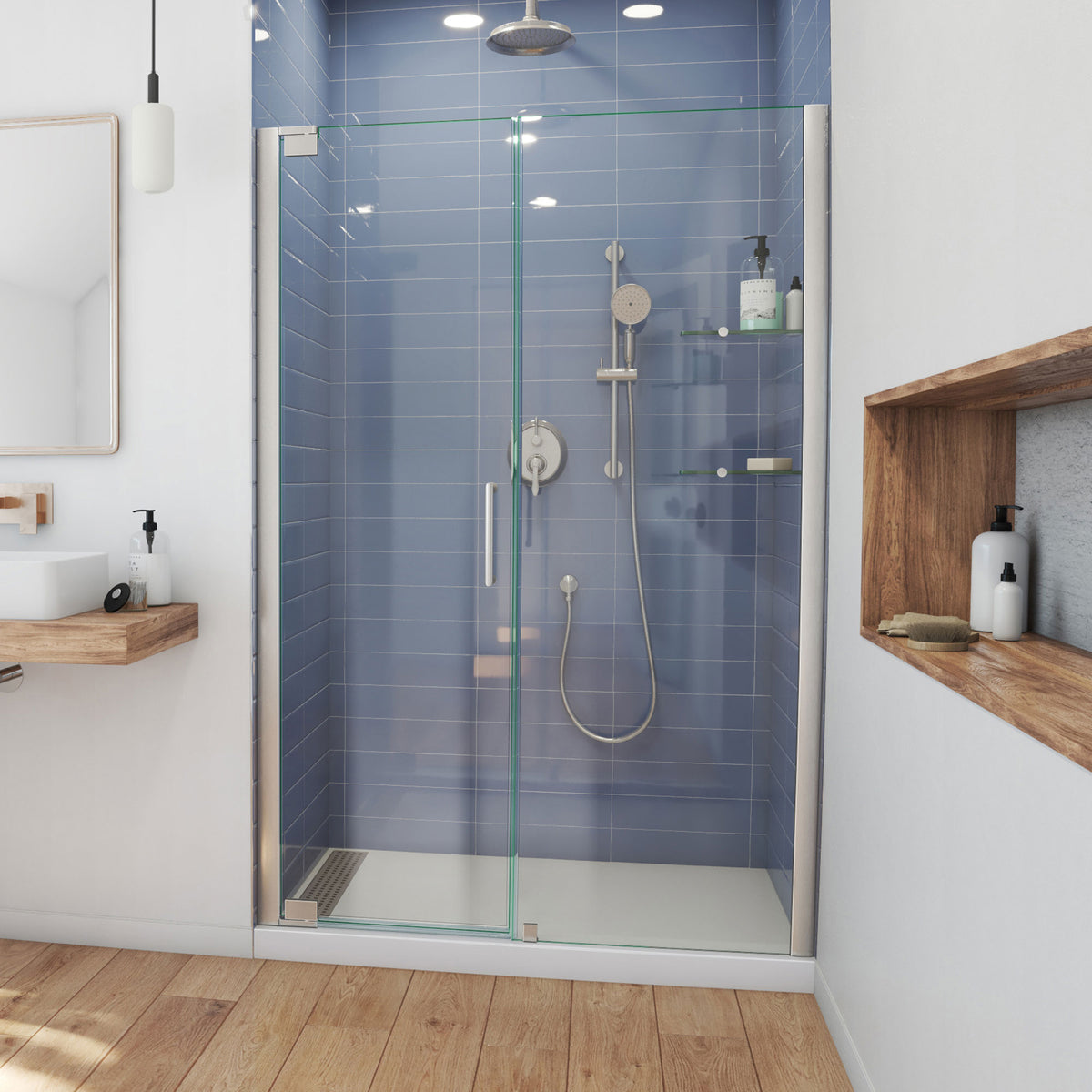 Elegance frameless pivot shower door in brushed nickel with wide inline panel for 49 to 62 inch openings