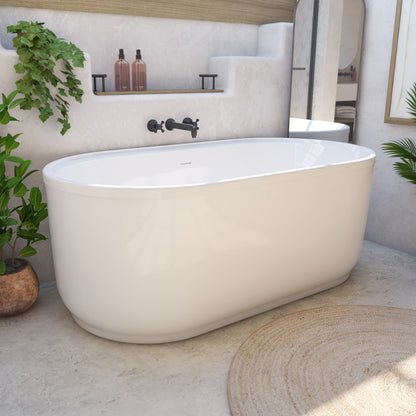 Encore 66 inch freestanding acrylic bathtub in gloss white with Brushed Brass drain, shown in a styled setting