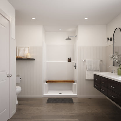 Straight teak shower bench resting across the side ledges of a white shower stall in a bright bathroom