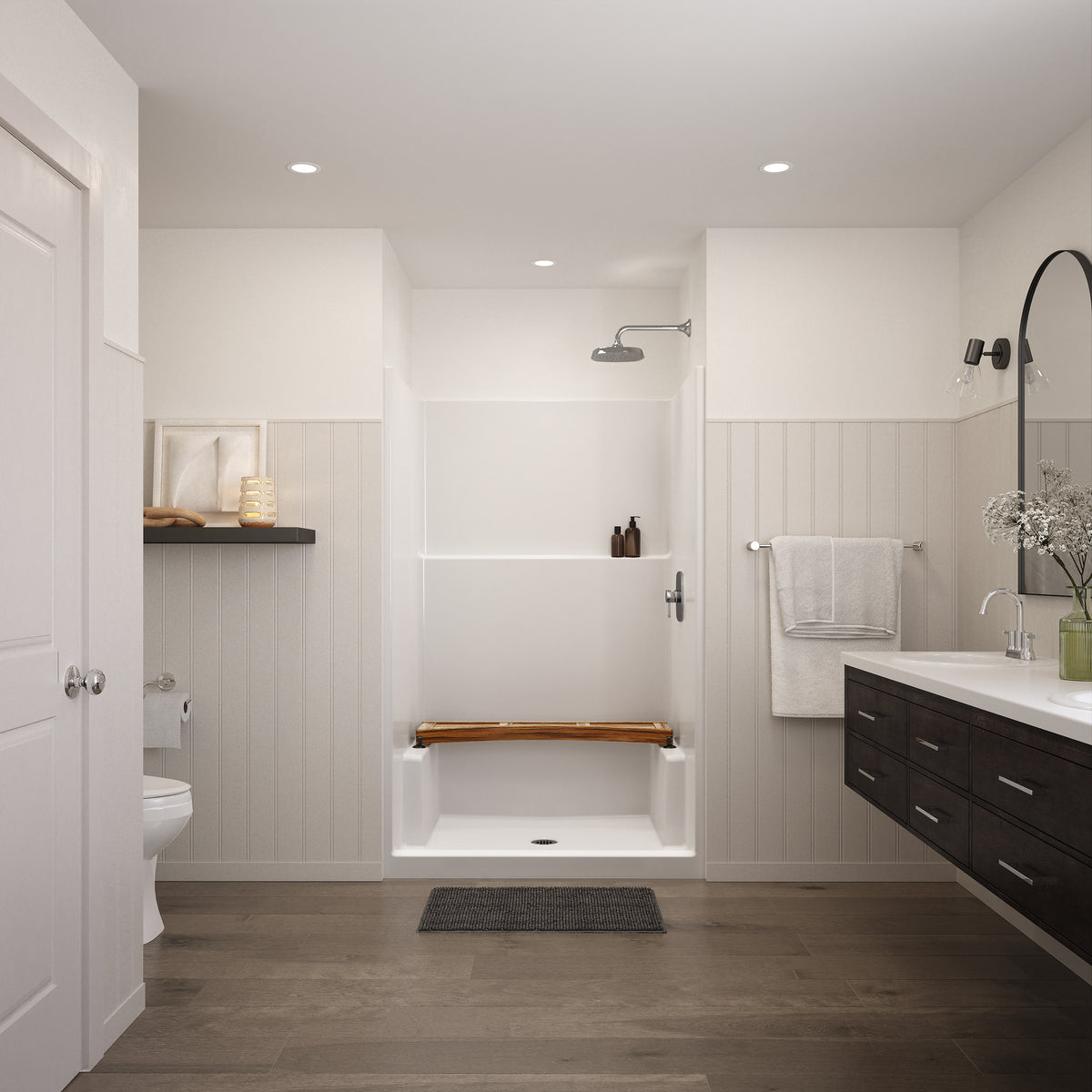 Curved teak shower bench resting across the side ledges of a white shower stall in a bright bathroom