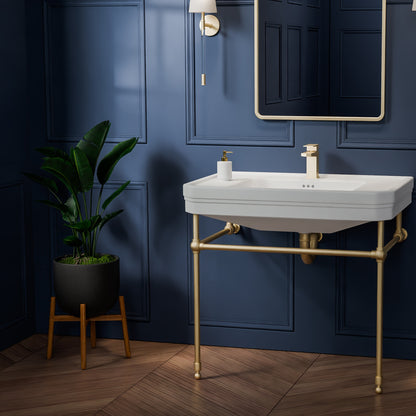 Valencia 31 inch console bathroom sink with Brushed Brass legs in a navy powder room, angled view