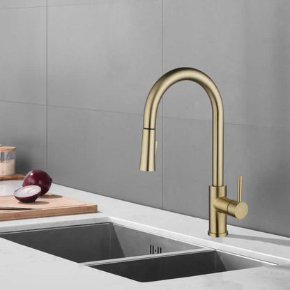 Halvard pull down kitchen faucet in Brushed Gold, installed over a kitchen sink