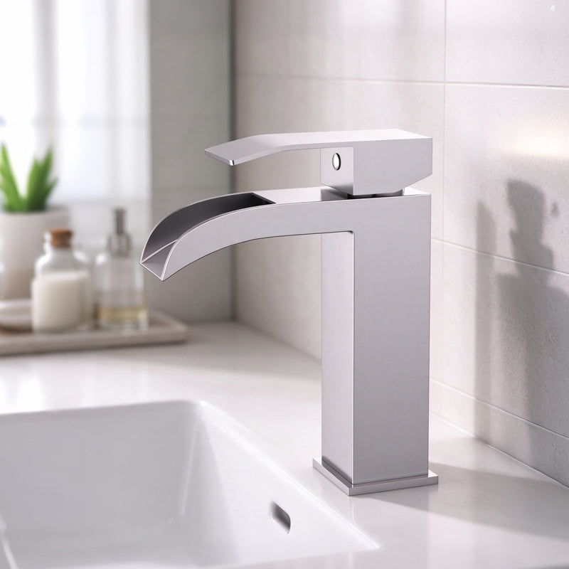 Torvald waterfall single hole bathroom faucet in Brushed Nickel, installed on a bathroom vanity