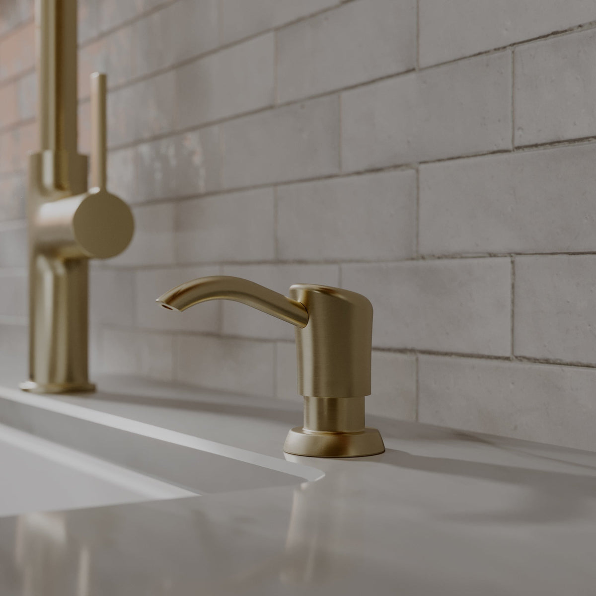 Ludlow kitchen soap dispenser in Spot-Free Champagne Bronze, installed beside a kitchen faucet