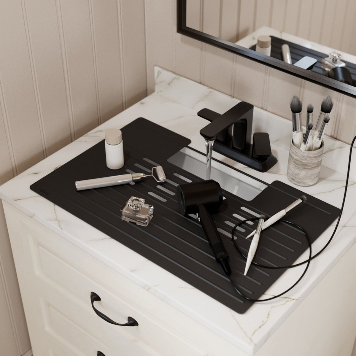 Roll up silicone vanity bowl mat in Black, laid over a bathroom sink