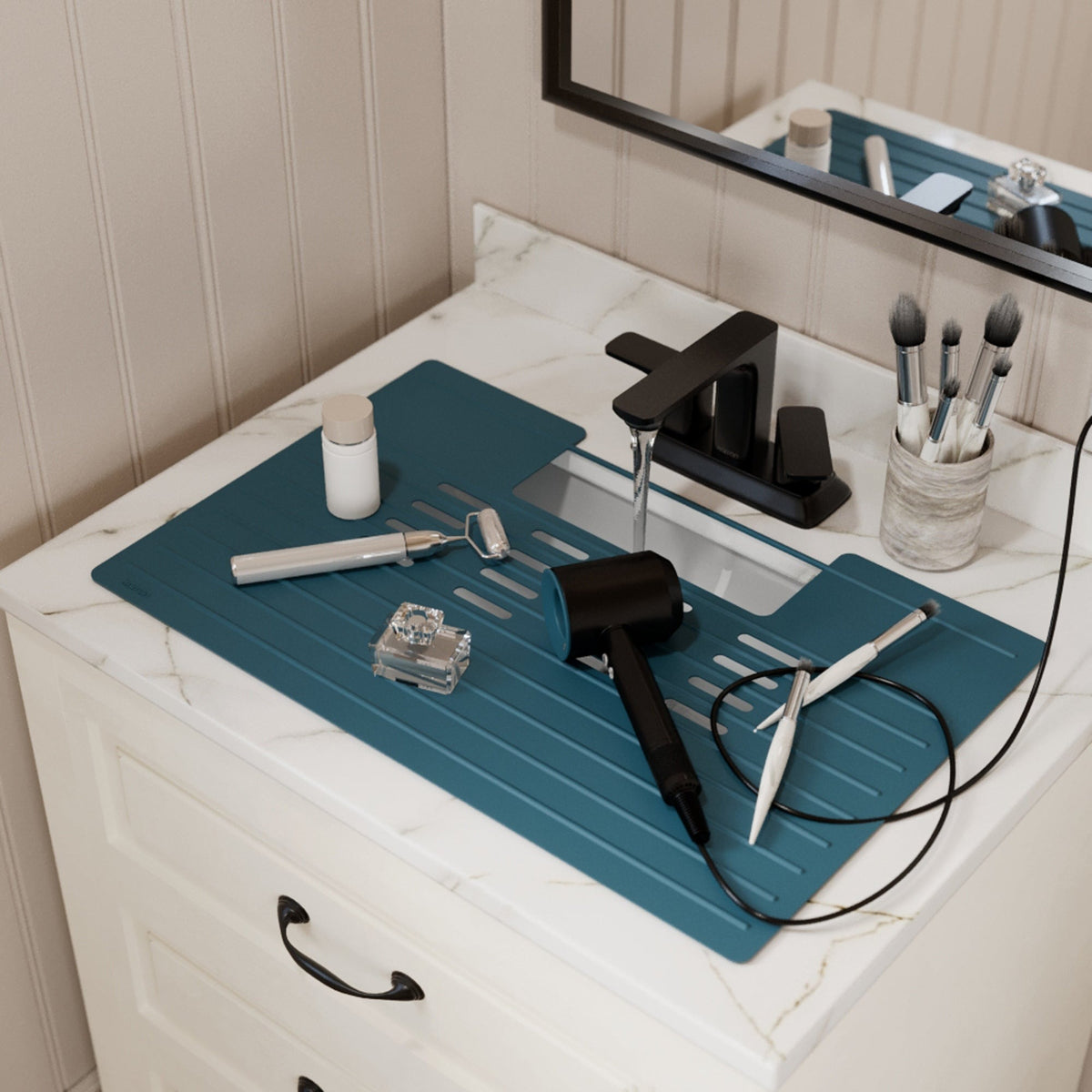Roll up silicone vanity bowl mat in Teal Blue, laid over a bathroom sink