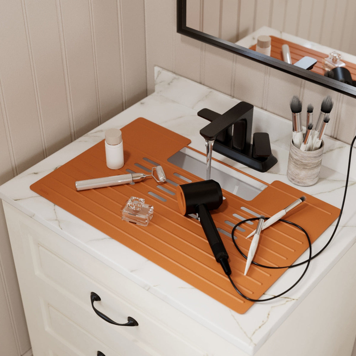 Roll up silicone vanity bowl mat in Burnt Orange, laid over a bathroom sink