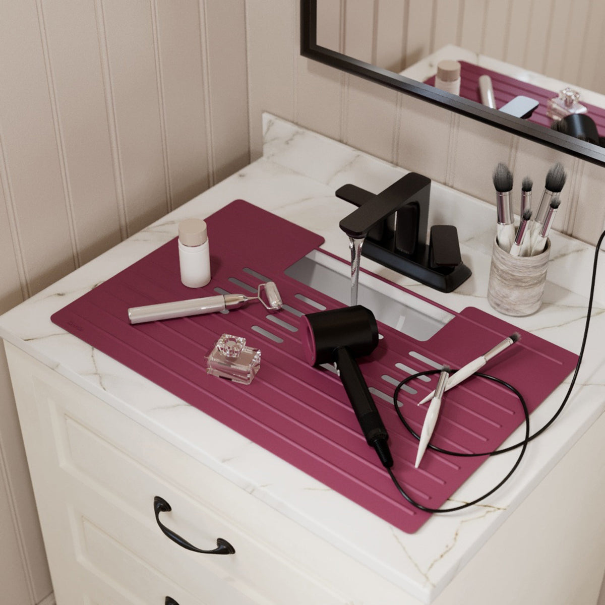Roll up silicone vanity bowl mat in Grape, laid over a bathroom sink