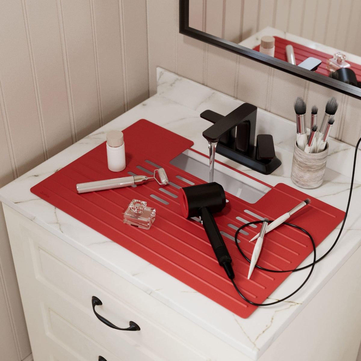 Roll up silicone vanity bowl mat in Raspberry, laid over a bathroom sink