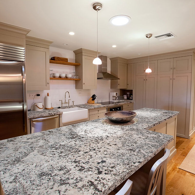 Oyster White granite countertop installed in a kitchen