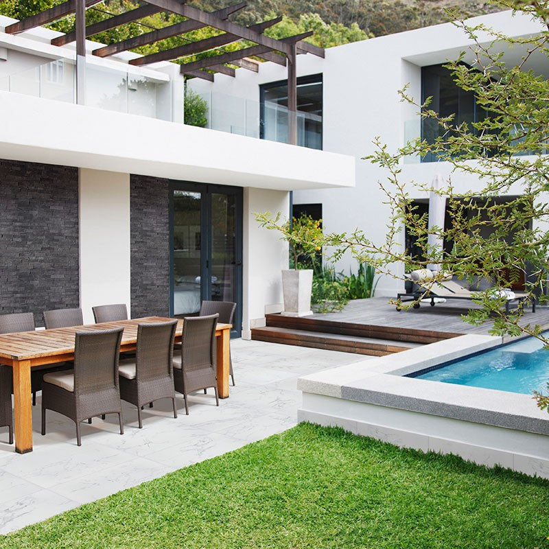 Praia Carrara Arterra Porcelain Pavers shown installed in a finished outdoor or living space