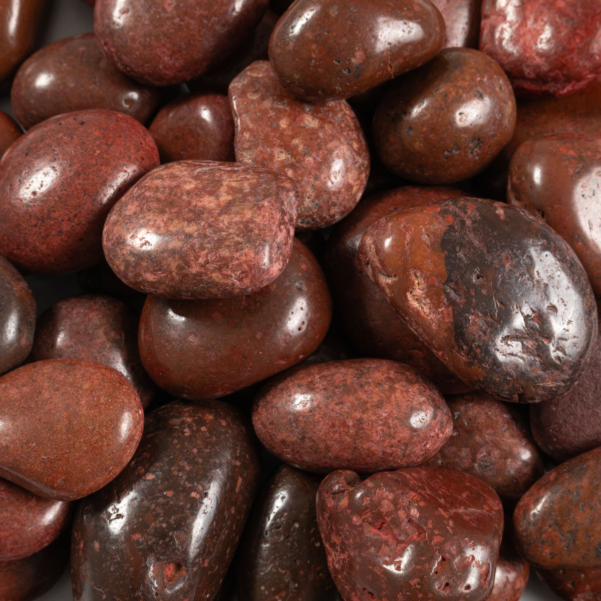 Red Super Polished landscape pebbles, close up product view showing color and texture