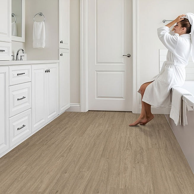 Wilmont Bleached Elm glue down luxury vinyl flooring installed in a bathroom