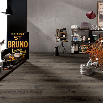 Wilmont Charcoal Oak glue down luxury vinyl flooring shown in a furnished room