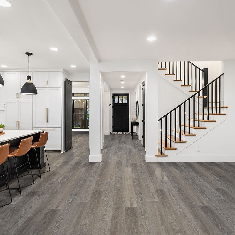 Wilmont Elmwood Ash glue down luxury vinyl flooring shown in a furnished room