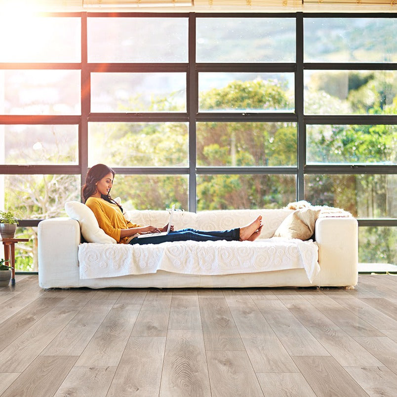 XL Cyrus Whitfield Gray SPC rigid core vinyl flooring shown in a furnished room