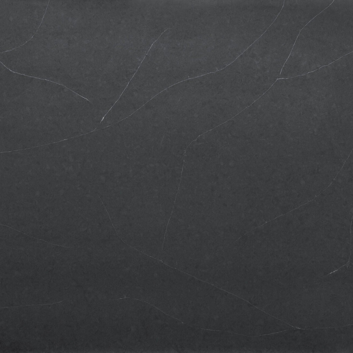 Regal Soapstone Matte silica free quartz slab sample by Stratus Surfaces, deep charcoal black with white and gray veining, matte finish, close up