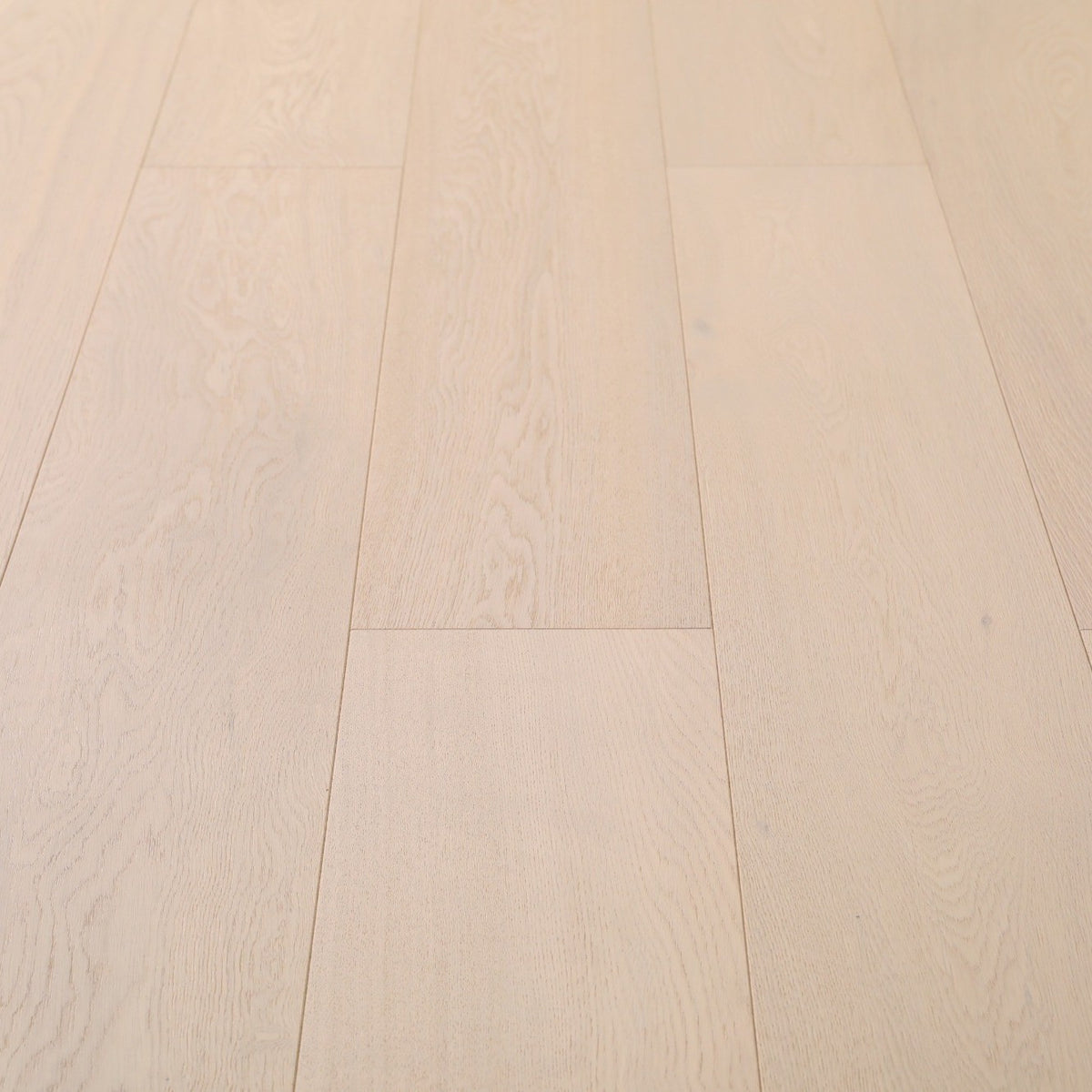 Progettista #125 Engineered Wood Flooring in a pale whitewashed tone, close view of the European oak planks with beveled edges