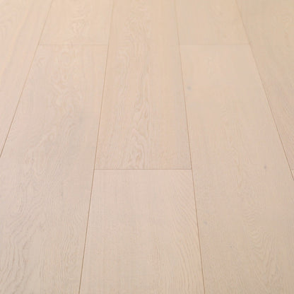 Progettista #125 Engineered Wood Flooring in a pale whitewashed tone, close view of the European oak planks with beveled edges